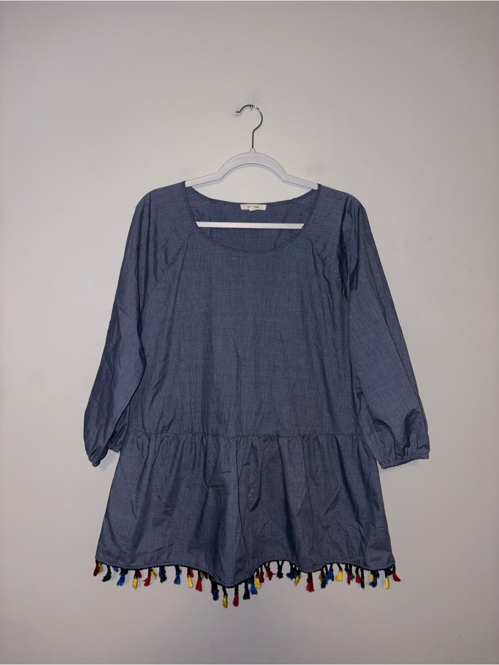 Pleione | Chambray Ruffle Peasant Top with Tassle Trim Hem